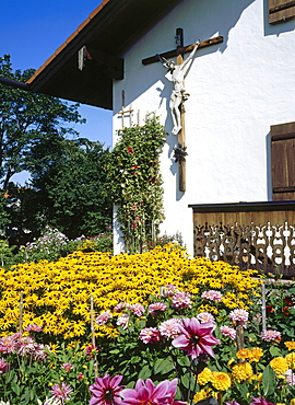 Cross mounted on a wall of Huber Country House, Gelting, Geretsried, Upper Bavaria, Germany, Europe