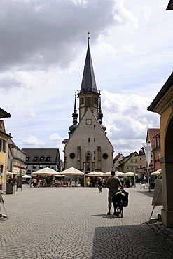 Cyclist, market square with Evangelische Kirche, Weikersheim, Baden-Wuerttemberg, Germany, Europe