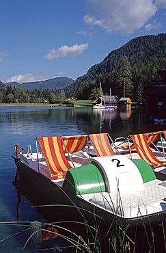 Paddle boats on the eastern shore of Lake Weissensee, Carinthia, Austria, Europe