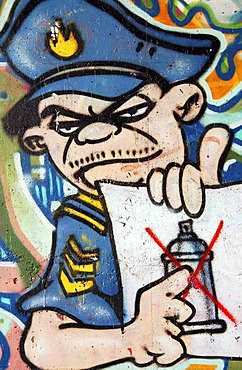 Graffiti prohibited ! Police officer shows the sprayed ban, Germany