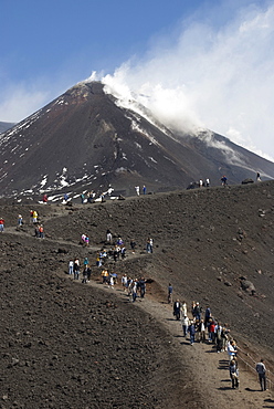 Tourists hiking to Mt. Etna, smoke, Sicily, Italy