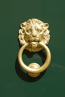 Lion head door knocker on a door in Polignano a Mare, Italy