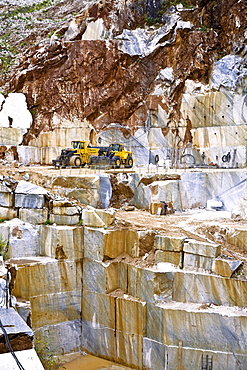 Mechanical shovel excavator in the marble stone pit of Carrara Tuscany Italy