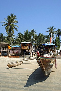 India, Goa, fishing boat and bamboo huts on Palolem