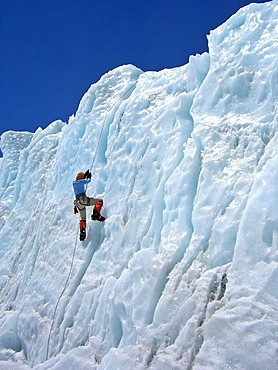 Female climber with crampons on a rope in lower Khumbu Icefall, Base Camp, 5300m, Mount Everest, Himalaya, Nepal