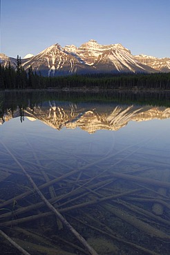 Sunrise on the Bow Range and crystal clear Herbert Lake, Banff National Park, Alberta, Canada