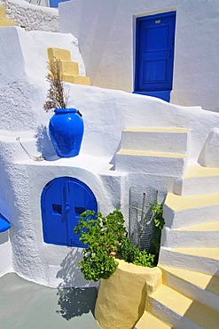 Inner courtyard with blue and yellow elements and a stairway in a typical cycladic architecture style, Oia, Ia, Cyclades, Greece, Europe