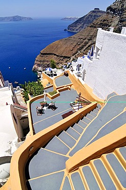 Stairway to the terrace of a small hotel in front of the inner side of the caldera with a steep drop to the blue sea, Thira, Fira, Santorini, Cyclades, Greece, Europe