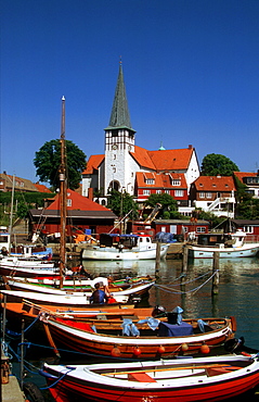 Boats in the harbor of Roenne in front of the Nicolaichurch, Bornholm, Denmark