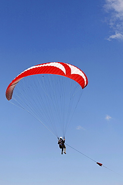 Paraglider hanging on the towrope, Lower Rhine, NRW, Germany