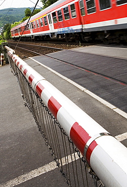 Train passing a closed railroad crossing, Bingen, Hesse, Germany, Europe