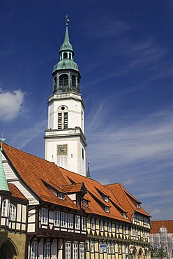 Tower of church Stadtkirche towers above the timbered houses of old town Celle, Lower Saxony, Germany