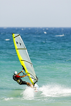 Windsurfer wearing helmet, Mediterranean coast, Spain