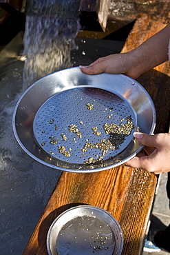 Teenagers "searching for gold", washing sand at Legoland, Guenzburg, Bavaria, Germany