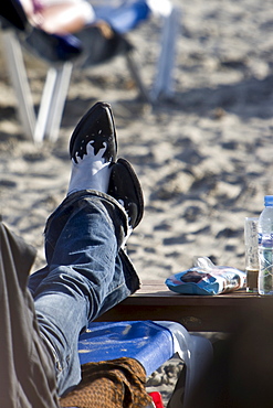 Man with Cowboy boots at Les Salinas beach, Ibiza, Balearen, Spanien