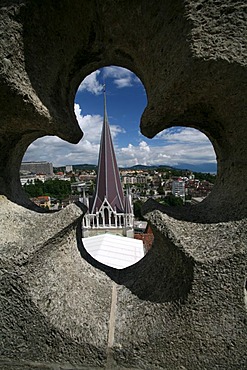 View through the balustrade to the roofs of Lausanne downtown. Tower on 11th century Cathedral Notre-Dame, Lausanne, Waadt, Switzerland