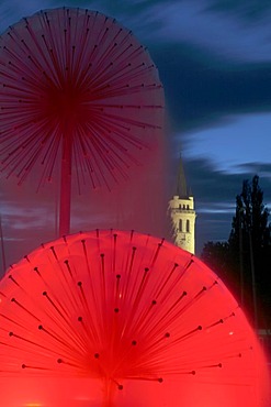 The ASCO fountain and the steeple of the Catholic church at the harbor entrance to Romanshorn at the Lake of Constance, Thurgau, Switzerland