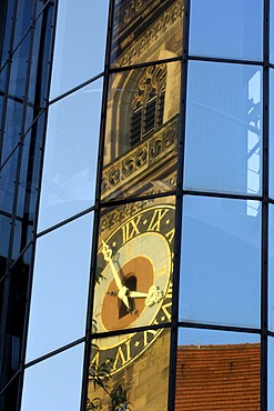 Stiftskirche (collegiate church) is reflected in glass cladding of a new building, Stuttgart, Baden-Wuerttemberg, Germany