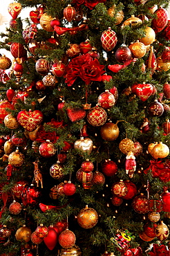 Detail shot, colourful Christmas ornaments hanging in Christmas tree