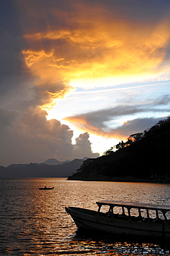 Sunset, back light, dramatic clouds, boat, Lake Atitlan, Guatemala, Central America