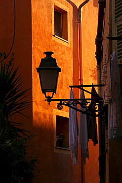 Lamp and laundry in a narrow lane in the historic centre of Nice, Cote d'Azur, France, Europe