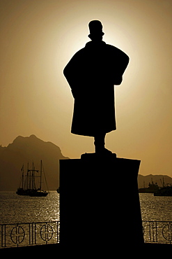 Silhouette of the monument to Alfonso Diogo in front of yachts moored in the bay of Mindelo on Sao Vicente Island, Cape Verde Islands, Cape Verde, Africa