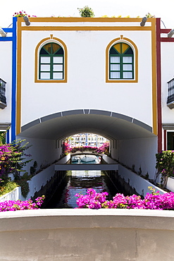 Canal thoroughfare under residential building, Puerto de Mogan, Gran Canaria, Canary Islands, Spain