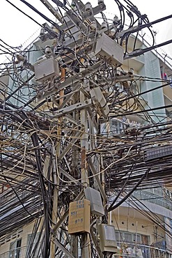 Tangled electrical and telephone cables in Saigon, Vietnam, Asia