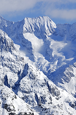 Clouds with freshly snow covered mountains in the Aletsch area, Goms, Valais, Switzerland