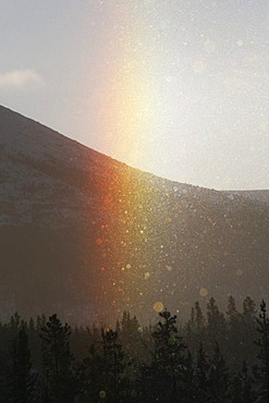 Sundog appearing in ice fog, rainbow colours, ice crystals, Yukon Territory, Canada