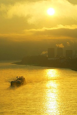 A freighter in the sunrise on the rhine near Bendorf, Rhineland-Palatinate, Germany