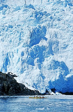 Kayaking under a glacial wall, Kenai Fjords National Park, Alaska, USA