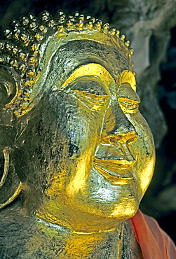 Gilded buddha head, curls ritually twisted from left to right, Luang Prabang, Laos, Asia