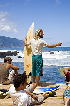 Young surfers in Sao Vincente, MadeiramPortugal waiting for tides looking into the ocean