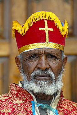 Ethiopian Orthodox Christianity portrait bishop with colourful crown in front of the New Cathedral Axum Ethiopia