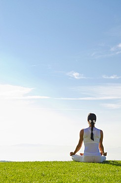 Young woman practising Hatha yoga outdoors, showing the pose padmasana, lotus pose, Nove Mesto, Okres Teplice, Czech Republic, Europe