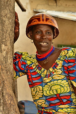 Woman wearing the calabash helmet that is typical for the region and a colourful dress, village of Tourou, Cameroon, Central Africa, Africa