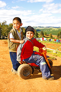 Two boys with a tricycle, Mapuche Indians, near Concepcion, Southern Chile, Chile, South America