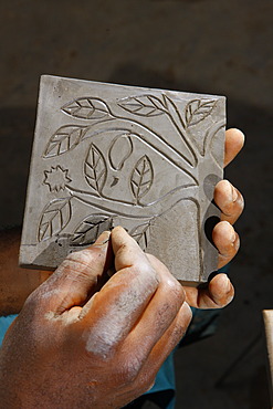 Ornament being carved into a decorative plate, manufacture of pottery, Bamessing, Cameroon, Africa