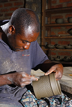 Man decorating a clay pot with ornaments, manufacture of pottery, Bamessing, Cameroon, Africa