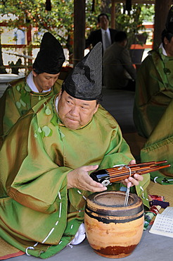 Musicians at the Aoi Festival holding a Sho wooden mouth organ in the Kamigamo Shrine in Kyoto, Japan, Asia