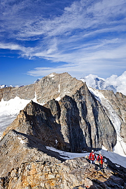 Hikers climbing Mt Angelo Grande in the Ortler mountain range, Mt Ortler and Mt Vertainspitz or Cima Vertana, South Tyrol, Italy, Europe