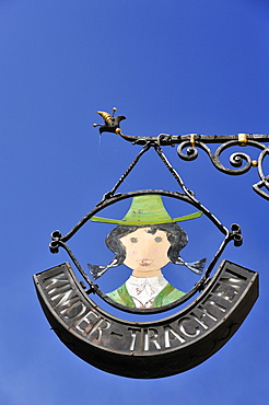 Wrought iron hanging sign for a children's traditional costume shop, Universitaetsplatz square, Salzburg, Austria, Europe