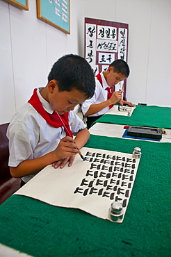 Selected children practicing calligraphy in the Children's Palace, Pyongyang, North Korea, Asia