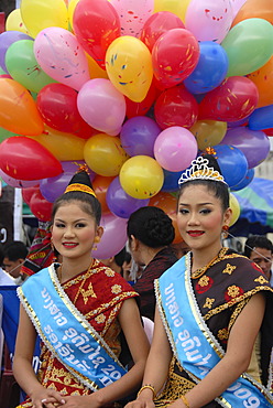 Festival, two beautiful young women of the Lao Loum ethnic group, beauty pageant, beauty queens, traditional clothes, hair styles, colourful balloons, Muang Xai, Udomxai province, Laos, Southeast Asia, Asia