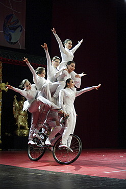 Chinese artists balance on a bicycle