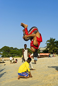 Acrobats practicing on the beach of Stone Town, Zanzibar, Tanzania, Africa