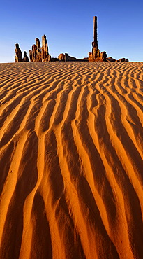 Sand dunes in front of Totem Pole and Yei Bi Chei rock formations after sunrise, Monument Valley, Navajo Tribal Park, Navajo Nation Reservation, Arizona, Utah, Southwest, United States of America, USA