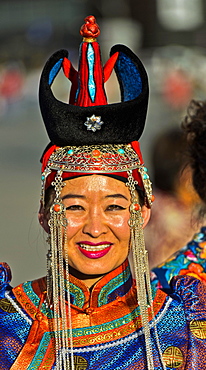 Young woman in traditional Deel clothes and hat with the typical conical tip, Festival of the Mongolian national costume, Ulaanbaatar, Mongolia, Asia