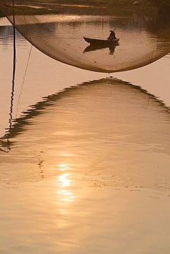 Fishing net and boatman, River Thu Bon, Hoi An, Vietnam, Asia